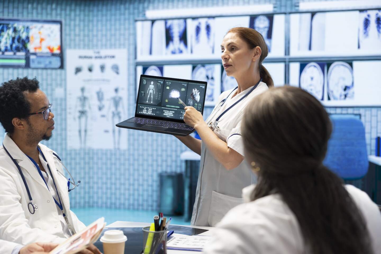 At a clinic, doctors and healthcare staff review test results and ct x rays. Professional medics collaborate on effective treatment plans and disease prevention, highlighting collective work.