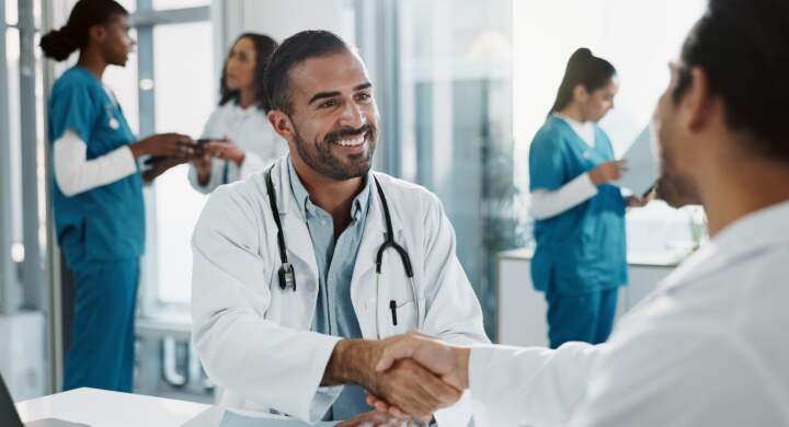Meeting, shaking hands and doctors in office at hospital for planning medical diagnosis or treatmen.