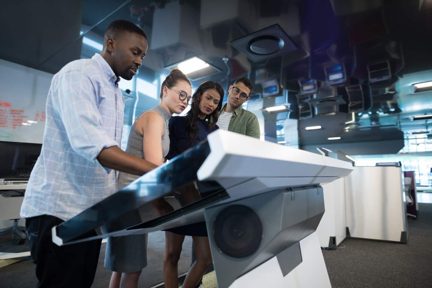 Business executives touching digital screen in futuristic office