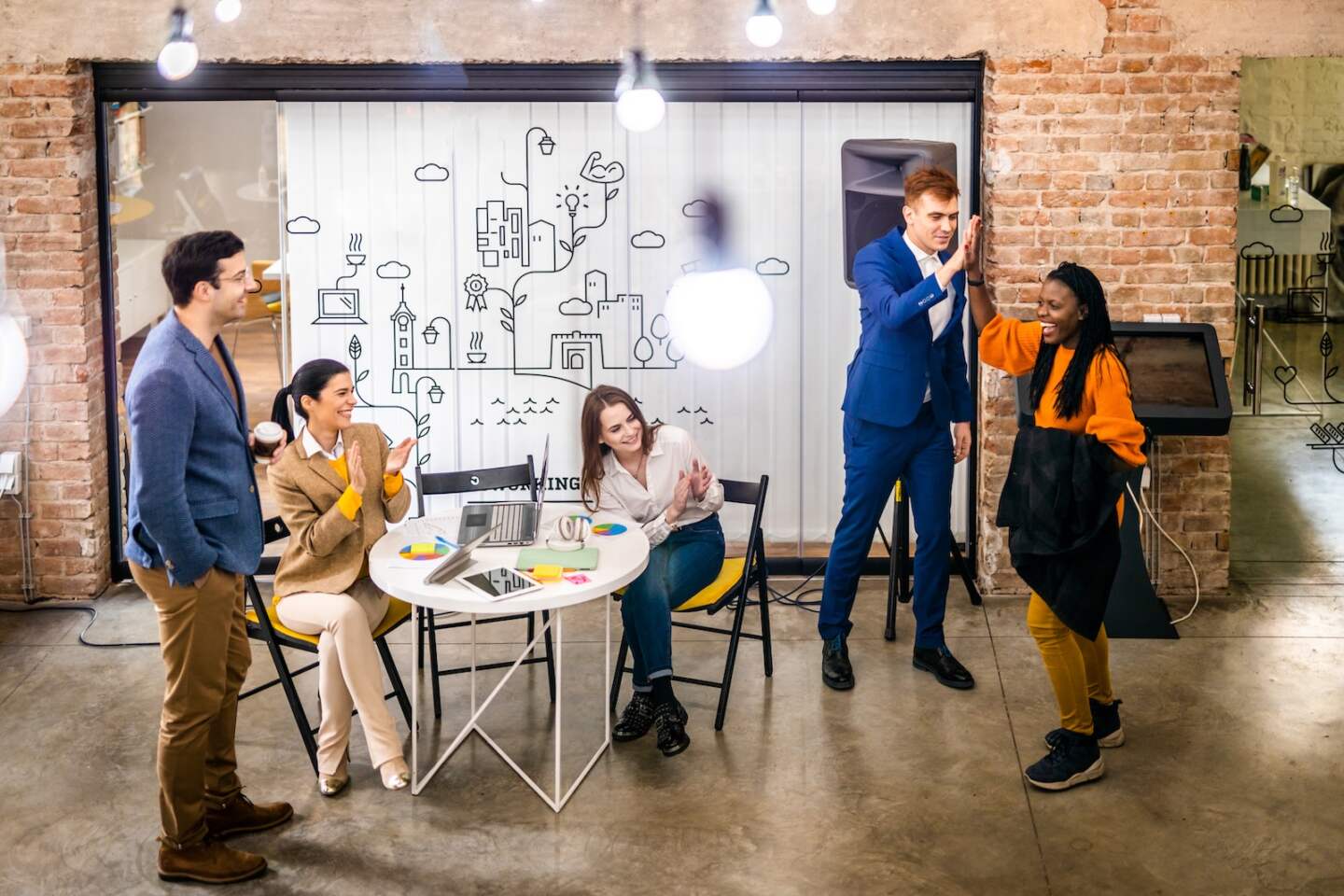 Project managers and employees brainstorming on ideas - Multi-ethnic group of workers having business meeting in a start-up office