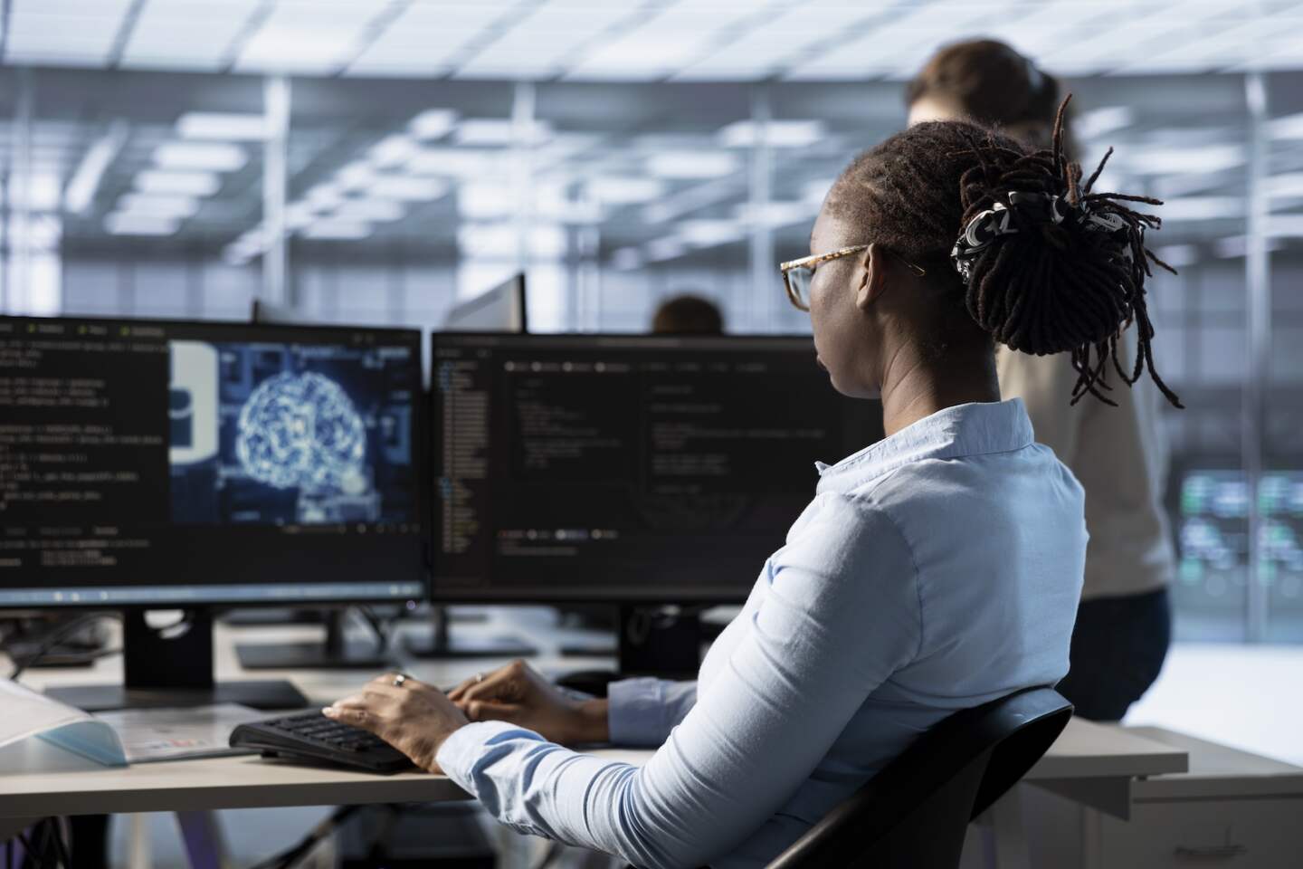 Woman typing on computer in server hub, monitoring data center energy consumption using AI software. Engineer managing supercomputers in server room using artificial intelligence tech