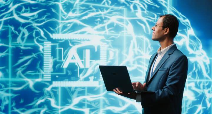 IT expert solving tasks on laptop device, running artificial intelligence programming scripts. Indian man using notebook to write lines of code for AI applications development, camera A