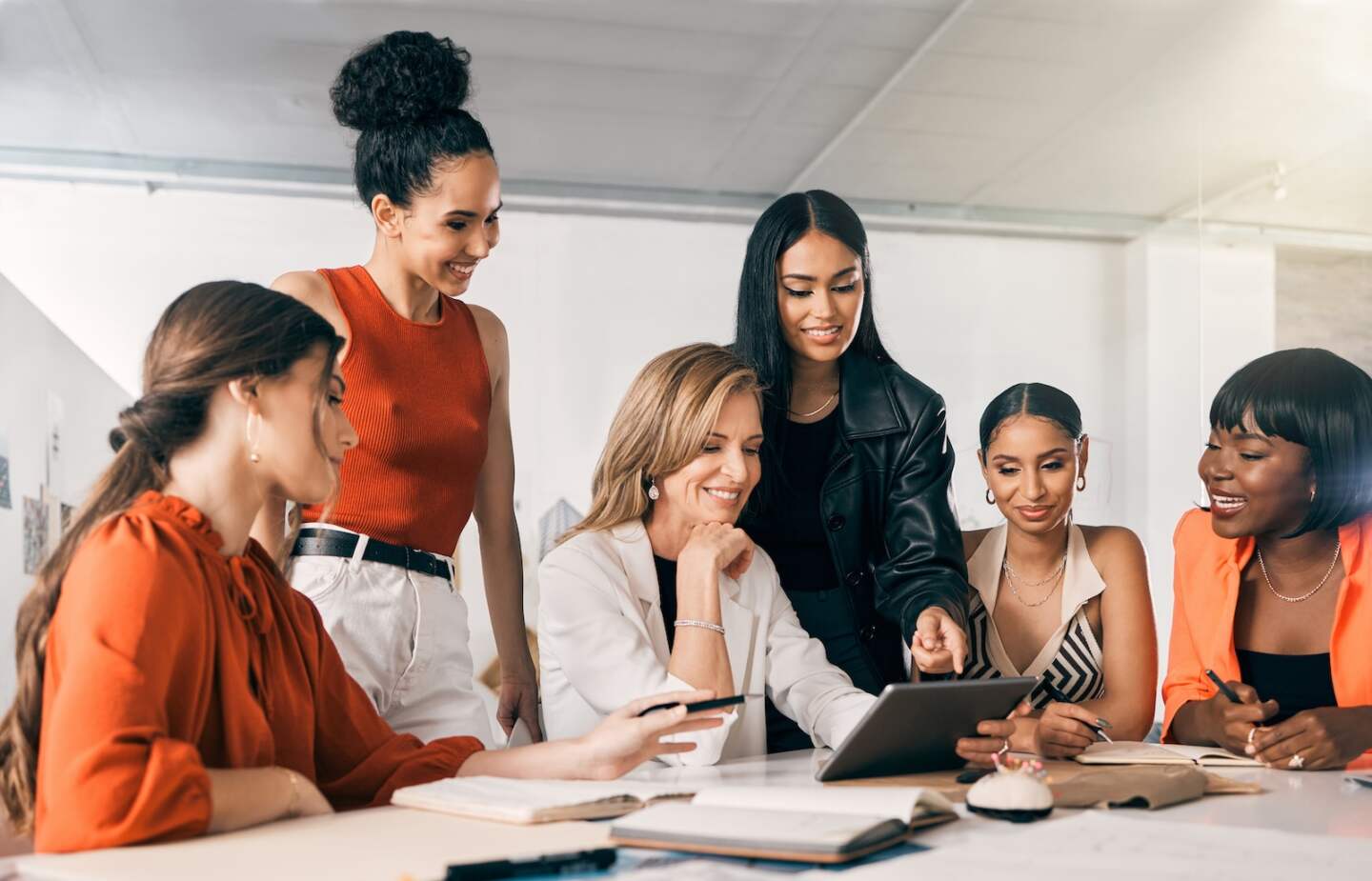 Shot of a group of businesswomen using a digital tablet together at work.