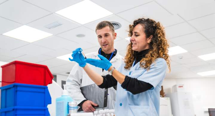 Male doctor and female nurse examine medical samples together in a clinical laboratory setting, focused and collaborative