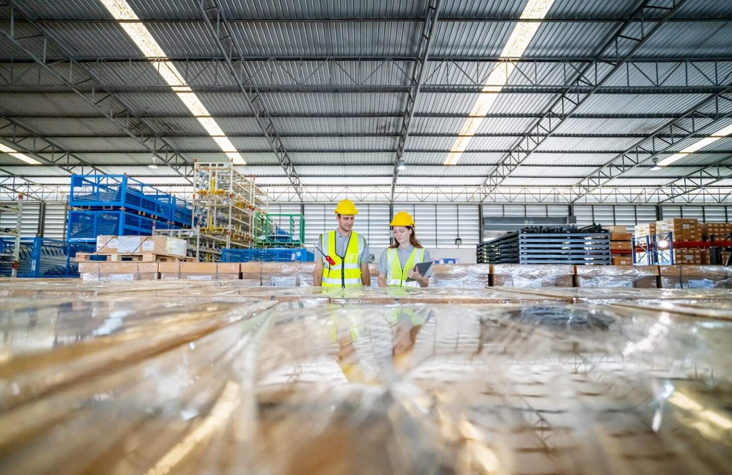 Storehouse workers are checking stock and inventory in retail warehouse. Business factory industry concept.