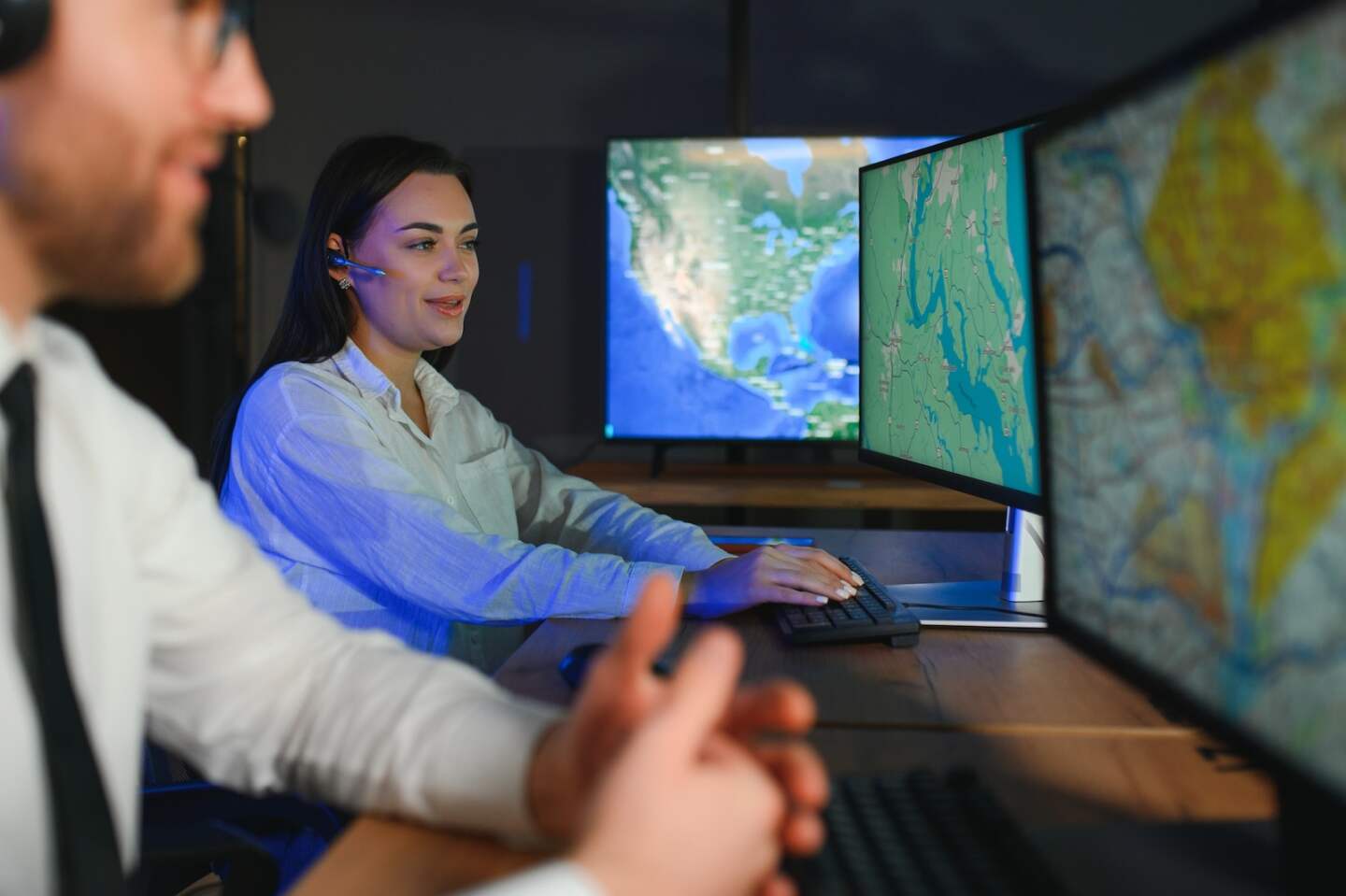 Diverse call center operators team use computers consulting clients in office.
