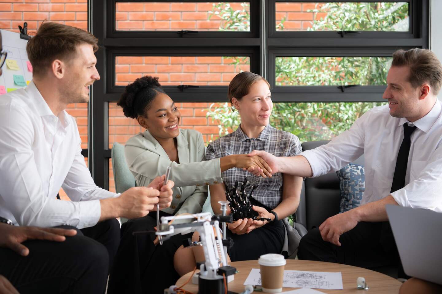 Group of diverse business people working together in the office, Brainstorming about the hand robot model to be used for production work