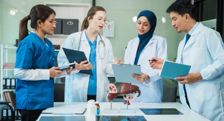 A diverse group of healthcare professionals, including doctors, nurses, and specialists, engaging