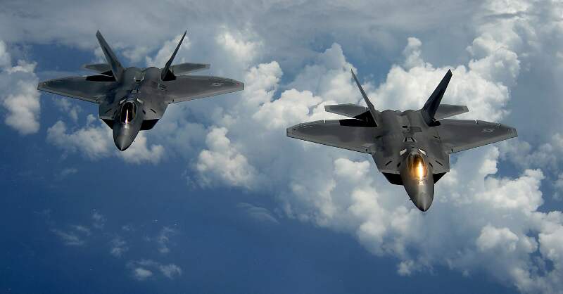 two military jets flying in the sky