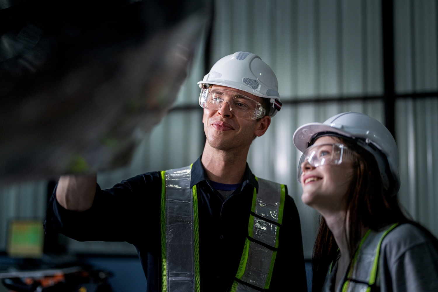 team engineers inspecting on machine with smart tablet. Worker works at heavy machine robot arm. The welding machine with a remote system in an industrial factory. Artificial intelligence concept.
