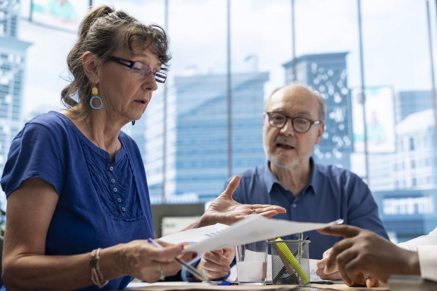 Senior couple engaged in consultation with a financial advisor about retirement planning, focusing on securing their financial future. Professional advice on investment strategy.