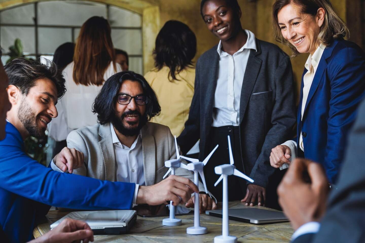Multiethnic business people working on sustainable renewable energy project inside office - Green alternative electricity concept