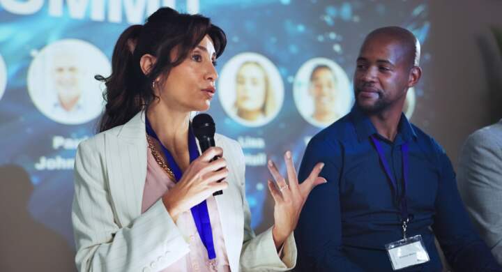 Stage, seminar and microphone with business people and technology for networking, industry panel an.